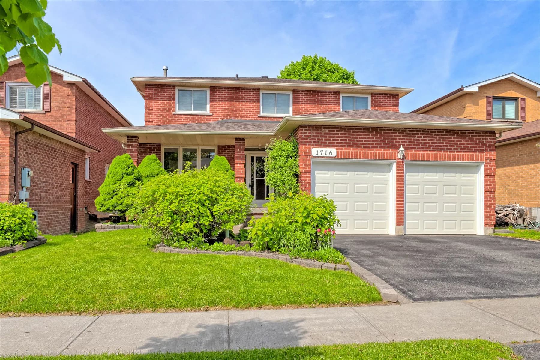 Front of 1716 Kirkwood Lane, a two-storey brick home with a double garage